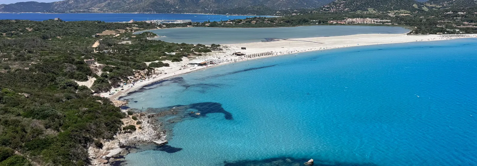 Aerial view of a white-sand beach and turquoise sea in Sardinia