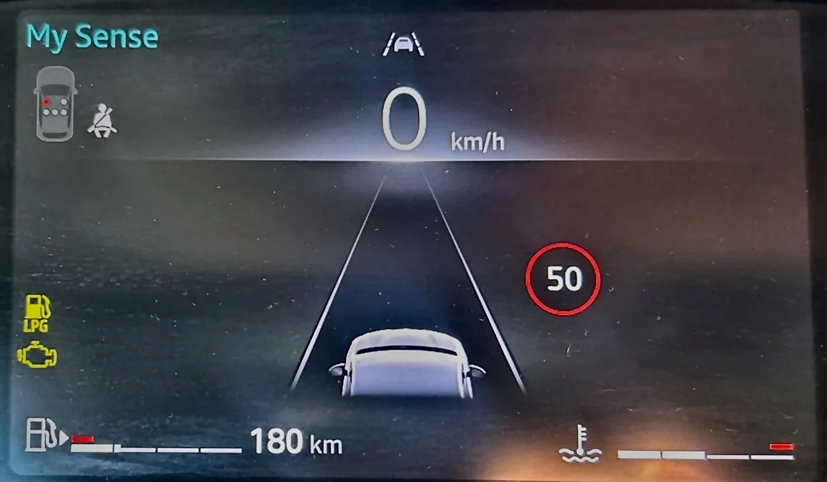 A rental car's dashboard: fuel bar almost empty with 180 km of range left, and the amber LPG and engine warning lights on